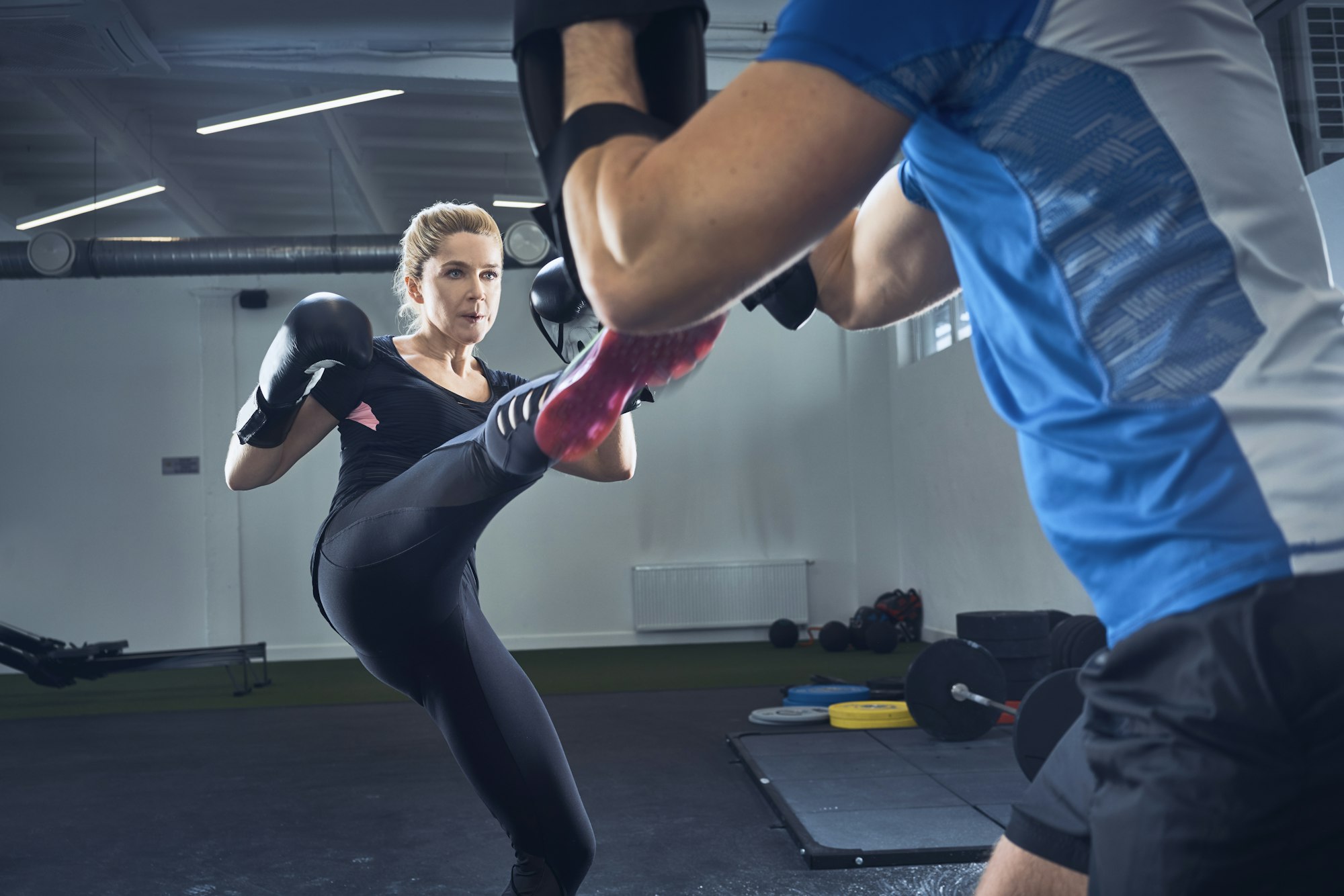 Woman practicing kickboxing at gym